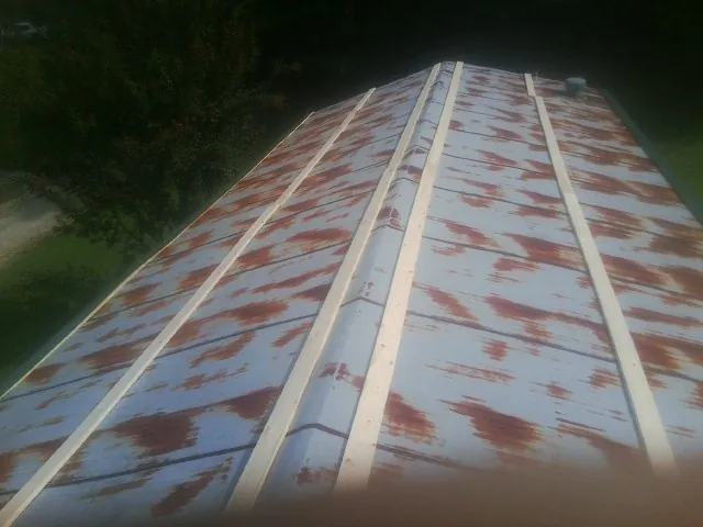 Rusted metal roof panels with new wood purlins before replacement — Storm Damage Roof Repair in Dresden by Roofing Brothers