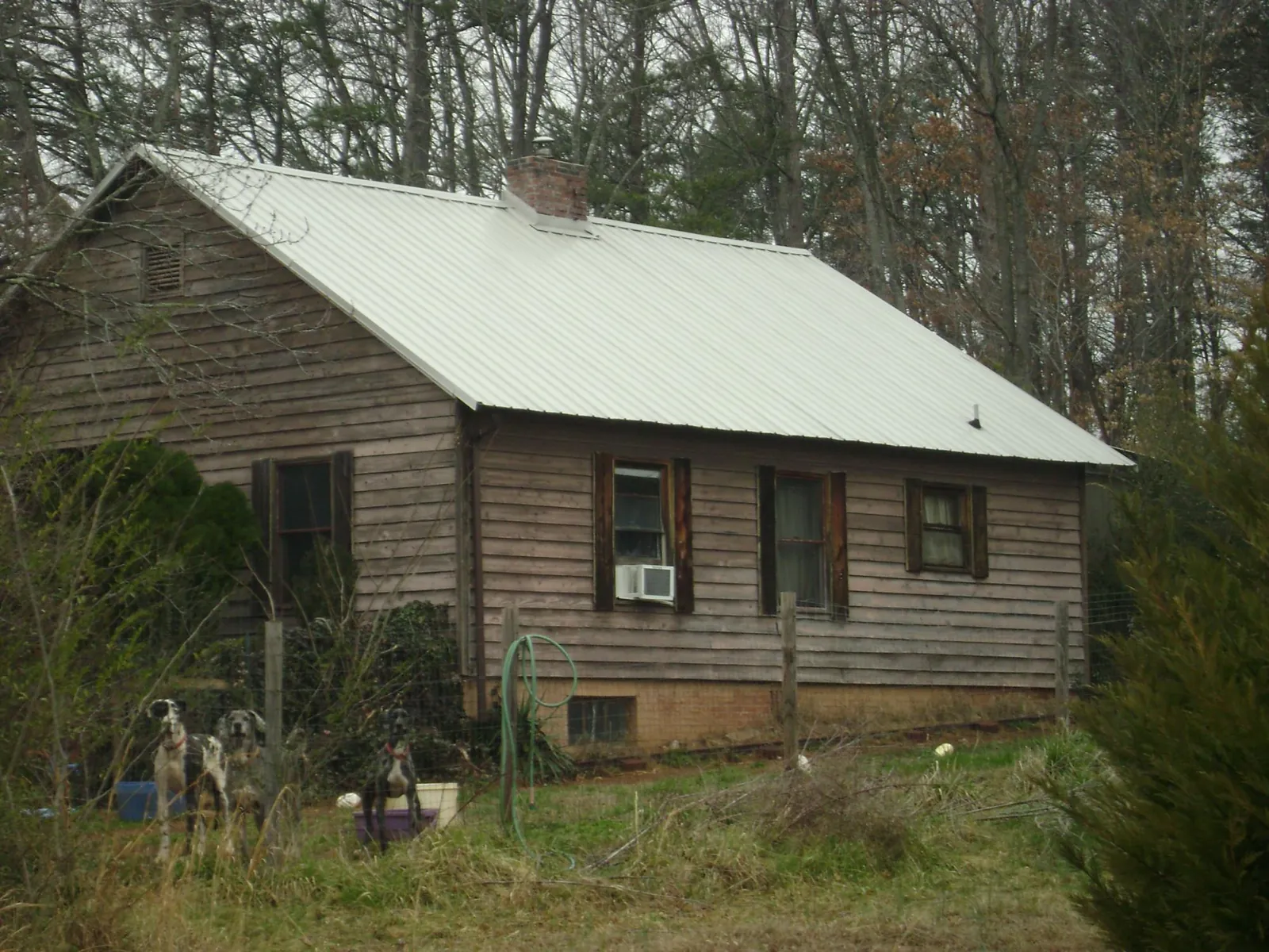 White metal roof on an old wood sided farmhouse, from a Metal Roof Installation job in Dresden